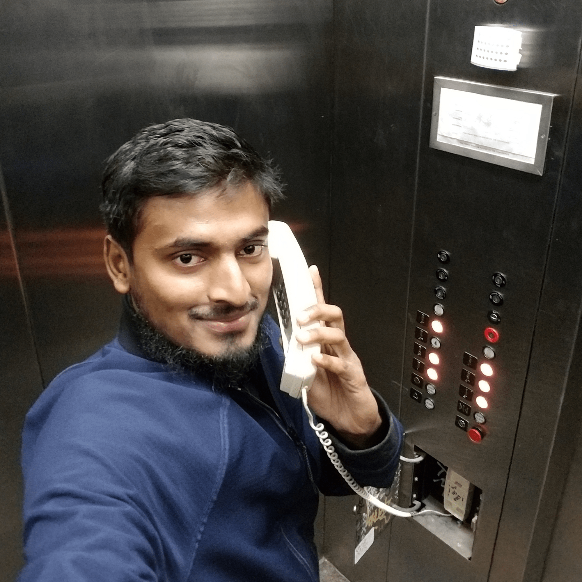 Naim stuck in the elevator on the phone